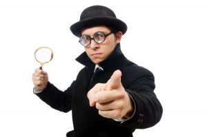 Detective with magnifying glass isolated on white